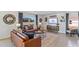 Living room featuring leather couches and a large TV at 5246 Salt Marsh Rd, Wimauma, FL 33598