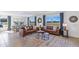 Spacious living room with leather sofas and large windows at 5246 Salt Marsh Rd, Wimauma, FL 33598