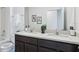 Double vanity bathroom with a large mirror and neutral tones at 5249 Salt Marsh Rd, Wimauma, FL 33598