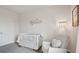 Bedroom with crib, rocking chair, and ample closet space at 5249 Salt Marsh Rd, Wimauma, FL 33598