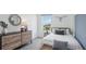 Bedroom with a bed, dresser, and stylish wall decor at 5249 Salt Marsh Rd, Wimauma, FL 33598