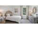 Bright bedroom with a bed, dresser, and large window at 5249 Salt Marsh Rd, Wimauma, FL 33598