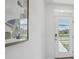Bright entryway with glass door and modern art at 5249 Salt Marsh Rd, Wimauma, FL 33598