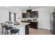 Modern kitchen with dark cabinets and an island at 5249 Salt Marsh Rd, Wimauma, FL 33598