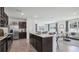 Open kitchen with island and stainless steel appliances at 5249 Salt Marsh Rd, Wimauma, FL 33598