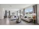 Open living room with neutral-toned furniture and large windows at 5249 Salt Marsh Rd, Wimauma, FL 33598