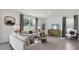 Spacious living room with light beige couch and large windows at 5249 Salt Marsh Rd, Wimauma, FL 33598