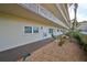 Exterior view of condo building showcasing landscaping and building features at 5725 80Th N St # 116, St Petersburg, FL 33709