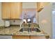 Kitchen boasts a double sink and granite countertops at 5725 80Th N St # 116, St Petersburg, FL 33709