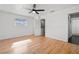 Light-filled bedroom with hardwood floors and ceiling fan at 6327 2Nd S Ave, St Petersburg, FL 33707