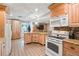 Modern kitchen with island, wood cabinets, and granite counters at 6327 2Nd S Ave, St Petersburg, FL 33707