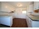 Bright kitchen with white cabinets and wood-look floors at 801 Woodruff Ave, Clearwater, FL 33756
