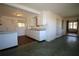 White kitchen cabinets, wood floors, and view into adjacent room at 801 Woodruff Ave, Clearwater, FL 33756