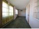 Living room with green curtains, tiled floor, and built-in shelving at 801 Woodruff Ave, Clearwater, FL 33756