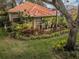 Single-story home with tile roof and lush landscaping at 1001 Live Oak Ne Ave, St Petersburg, FL 33703