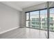 Bedroom with gray tile floors and a large window offering a city view at 111 N 12Th St # 1812, Tampa, FL 33602