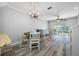 Bright dining room features a round table, chandelier, and wood-look floors at 11246 Kapok Grand Cir, St Petersburg, FL 33708