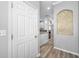 Bright hallway with wood-look floors and access to kitchen at 11246 Kapok Grand Cir, St Petersburg, FL 33708