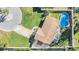 Aerial view of a house with a pool and circular driveway at 11398 88Th Ave, Seminole, FL 33772