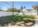 Large grassy backyard with a white fence at 11398 88Th Ave, Seminole, FL 33772