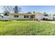 Newly renovated house with green lawn and white fence at 11398 88Th Ave, Seminole, FL 33772