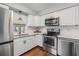 Modern kitchen featuring stainless steel appliances and white shaker cabinets at 11398 88Th Ave, Seminole, FL 33772