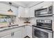 Renovated kitchen, white cabinets, stainless steel appliances and marble countertops at 11398 88Th Ave, Seminole, FL 33772