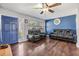 Living room with blue accent wall, hardwood floors, and comfy seating at 11398 88Th Ave, Seminole, FL 33772