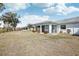 Backyard view of house with screened patio at 1212 Wild Feather Ln, Sun City Center, FL 33573