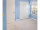 Light blue bedroom with carpeting and double door closet at 1241 Redondo Way, Wesley Chapel, FL 33543