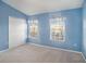Light blue bedroom with carpeting and double door closet at 1241 Redondo Way, Wesley Chapel, FL 33543