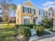 Front view of two-story townhome, featuring landscaping and walkway at 1241 Redondo Way, Wesley Chapel, FL 33543