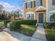 Townhome entrance with walkway, landscaping, and gray door at 1241 Redondo Way, Wesley Chapel, FL 33543