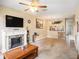 Living room with fireplace, TV, and view into kitchen area at 1241 Redondo Way, Wesley Chapel, FL 33543