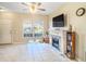Living room featuring fireplace, large window, and tiled floors at 1241 Redondo Way, Wesley Chapel, FL 33543