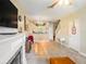 Open living room with fireplace, kitchen passthrough, and tiled floors at 1241 Redondo Way, Wesley Chapel, FL 33543