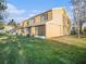 Exterior view of tan townhouse with screened patio at 1241 Redondo Way, Wesley Chapel, FL 33543