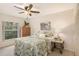 Bedroom with leafy patterned bedding, wood dresser, and large window at 1250 S Pinellas Ave # 713, Tarpon Springs, FL 34689