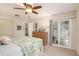 Bedroom with leafy patterned bedding and sliding glass door to patio at 1250 S Pinellas Ave # 713, Tarpon Springs, FL 34689