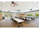 Bright community room with tables, chairs, and ceiling fans at 1250 S Pinellas Ave # 713, Tarpon Springs, FL 34689