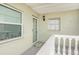 Condo exterior showcasing a light-green building with white trim and a small balcony at 1250 S Pinellas Ave # 713, Tarpon Springs, FL 34689