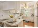 Kitchen with white cabinets, breakfast bar, and modern appliances at 1250 S Pinellas Ave # 713, Tarpon Springs, FL 34689