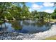 Serene pond with fountain, surrounded by lush greenery at 1250 S Pinellas Ave # 713, Tarpon Springs, FL 34689