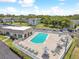 Community pool with patio, lounge chairs, and umbrellas at 1250 S Pinellas Ave # 713, Tarpon Springs, FL 34689