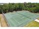 Two well-maintained tennis courts surrounded by fencing at 1250 S Pinellas Ave # 713, Tarpon Springs, FL 34689