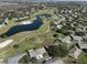 Aerial view showcasing home's location in a community near a golf course and pond at 1318 Leland Dr, Sun City Center, FL 33573