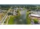 Aerial view of community, highlighting lake, homes and clubhouse at 1318 Leland Dr, Sun City Center, FL 33573