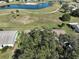 Aerial view of home and community, showcasing golf course, lake, and lush landscaping at 1318 Leland Dr, Sun City Center, FL 33573