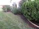 Landscaped backyard with flowering bushes and neatly trimmed shrubs at 1318 Leland Dr, Sun City Center, FL 33573