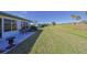 Home's backyard features a patio, lush grass, and distant golf course views at 1318 Leland Dr, Sun City Center, FL 33573
